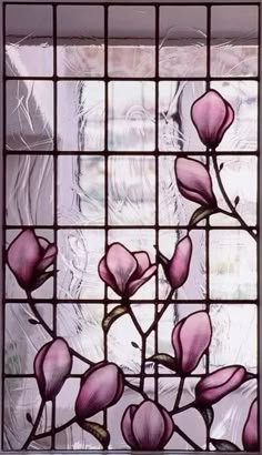 a stained glass window with pink flowers on it