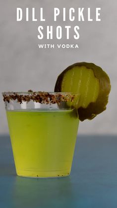 a green drink with a lime wedge in it and the words dill pickle shots with vodka