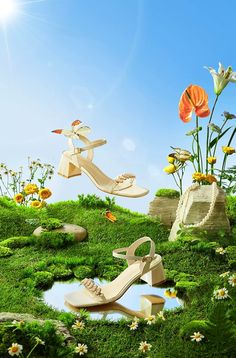 the woman's shoes are in the grass with flowers and butterflies flying around them