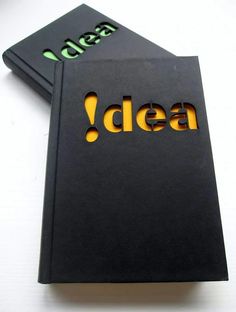 two black notebooks with the word idea written on one side and the word idea printed on the other