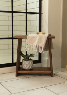 a potted plant sitting on top of a wooden stand