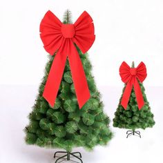 two small christmas trees with red bows on them