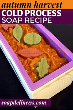 an autumn harvest cold process soap recipe in a purple container with leaves and acorn on top