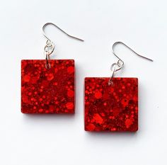 red square earrings with silver hooks on white background