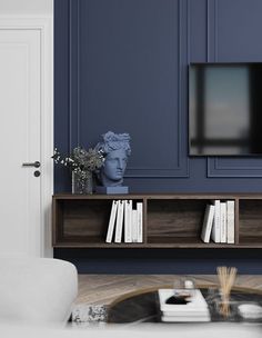 a living room with blue walls and white furniture