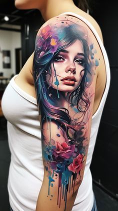 a woman's arm with watercolor paint and flowers on it, while she is wearing