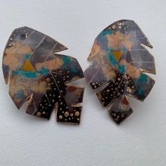 HELLO FALL!! These Large BLACK fall LEAVES are made with 2 different materials, shrink plastic and Resin. The original artwork on the earrings is an painting of mine originally curated on canvas. On the original painting,acrylic paints and foils were utilized on canvas along with modeling paste to add  texture and depth. Then off a tedious quest of finding the best method of preserving and transferring my art onto jewelry. Afterwards, I may enhance with more metallic alcohol ink colors, gold and silver foils, etc.. The size is approximately 2 inches in width and 3 inches in length.   They are SUPER lightweight and downright Gorgeous! Each piece Curated, has its own Identity, No two leaves will be exactly the same. Slight variation should be expected in each individual piece of art. Ear can Festival Earrings, Modeling Paste, Hand Painted Earrings, Earrings Resin, Painted Earrings, Art Earrings, Shrink Plastic, Eye Earrings, Hello Fall