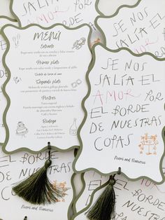 the menus are decorated with green and pink writing on white paper, along with tassels