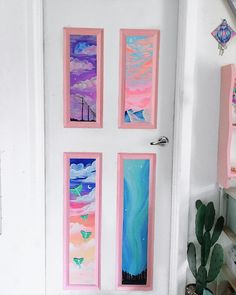 three paintings are hanging on the wall next to a potted cacti in front of a door