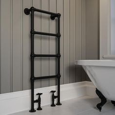 a bathroom with a bathtub, sink and towel rack in the middle of it