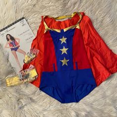 a red, blue and gold costume laying next to a magazine