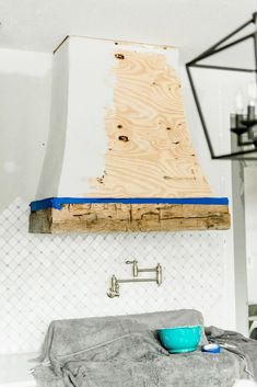 a stove top oven sitting next to a wall with a blue bowl on the counter