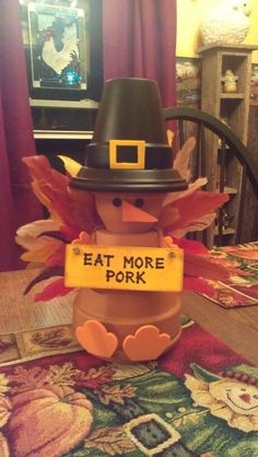 a thanksgiving turkey with a sign that says eat more pork