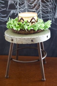 a small cake sitting on top of a wooden table next to a chalkboard wall