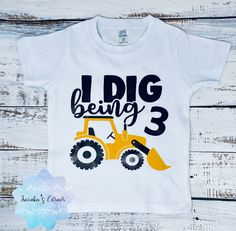 a white shirt that says i dig being 3 with a yellow bulldozer on it