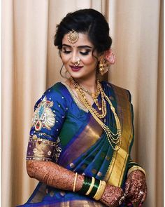 a woman in a blue and gold sari