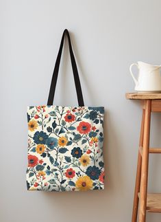 Surprise her with our Scandinavian Floral Folk Art Tote Bag, a perfect springtime companion. Adorned with red and green flowers, this custom tote bag celebrates the vibrant essence of Nordic art. It's an ideal gift for mom or any special woman in your life, offering both style and practicality wrapped in the timeless beauty of Scandinavian design. 𝐃𝐞𝐭𝐚𝐢𝐥𝐬: .: 5 color Cotton handle options  .: 100% Polyester body - Extremely strong and durable synthetic fabric that retains its shape and dr Artistic Bags For Everyday Use In Spring, Artistic Tote Bags For Spring, Artistic Spring Tote Bag, Multicolor Floral Print Tote Canvas Bag, Multicolor Floral Print Canvas Tote Bag, Handmade Spring Canvas Tote Bag, Multicolor Floral Print Canvas Bag For Everyday, Multicolor Rectangular Canvas Bag With Floral Print, Gift Multicolor Floral Print Shoulder Bag