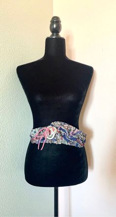 "This trendy vintage belt is perfect for pairing with jeans or wrapping around a dress! Great for any fan of 80s fashion! Navy blue belt with shades of pink and multi print with a silver deco on the front. A very cool belt to add to your wardrobe collection! This is a stretch belt with velcro. length: 32\" Width: 10.25\" (bulk) 21.75\" (strap) US SHIPPING  FREE International shipping, please see the rate Please add our shop as a ❤ favorite so you can find us again! Our website is minxandonyx.com Www.facebook.com/minxandonyx @minxandonyx follow us on Instagram Thank you for shopping at Minx and Onyx Vintage!" Summer Festival Corset Belt, Adjustable Multicolor Belts For Spring, Adjustable Multicolor Belt For Spring, Multicolor Adjustable Belt For Spring, Spring Party Fabric Belt, Vintage Adjustable Multicolor Belts, Vintage Adjustable Belts For Spring, Bohemian Rope Belt For Summer, Adjustable Belts For Summer Festival