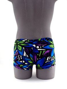 "Designed with a vibrant look sure to turn heads,this men's swimsuit lights up the beach or pool in refreshing style,this eye-catching stretch nylon square cut swimsuit for men stands out for all the right reasons. MADE IN USA PLEASE NOTE: All print fabric designs swimsuits varies, no two are alike. Drawcord waist 7\" Inch Side seams 3/4 inch waist elastic 3/8 inch leg elastic Center seam front pouch" Fitted Tropical Swim Trunks For Pool, Fitted Multicolor Boxer Briefs For Summer, Summer Stretch Multicolor Boxer Briefs, Summer Multicolor Stretch Boxer Briefs, Blue Stretch Boxer Briefs For Beach Season, Summer Blue Boxer Briefs For Poolside, Stretch Beachwear Boxer Briefs For Beach Season, Stretch Beachwear Boxer Briefs For Summer, Tropical Green Shorts For Swimming