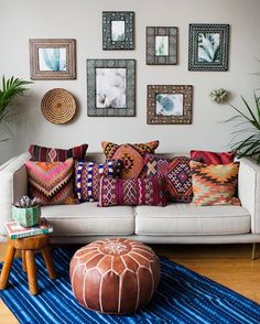 a living room filled with lots of colorful pillows