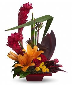 a vase filled with lots of different colored flowers and greenery on top of a white background