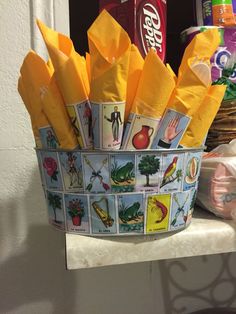 a basket filled with yellow napkins sitting on top of a counter next to a shelf