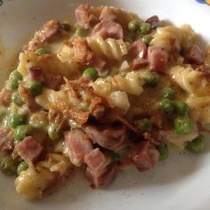 a white plate topped with pasta and meat