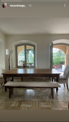 a dining room table with two benches in front of it