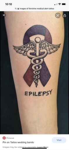 a tattoo on the leg of a woman with a cadus symbol and words that read epilepy