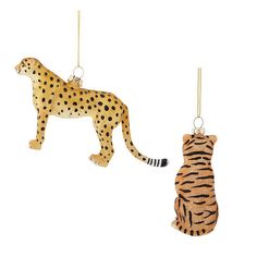 two ornaments in the shape of a cheetah and a tiger hanging from strings