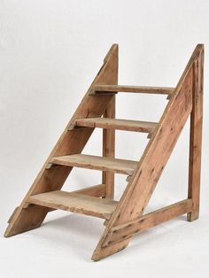 an old wooden step ladder with no one on it's legs and bottom steps