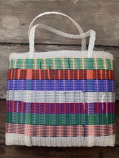 a multicolored bag sitting on top of a wooden table