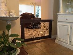 a living room filled with furniture and a baby gate