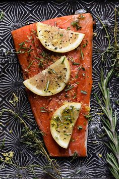 salmon with lemons and herbs on a platter