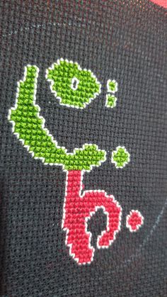 a close up of a knitted piece of cloth with an image of a flower