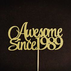 a cake topper with the words awesome since 1989 written in cursive font