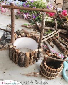 a pile of wood sitting on top of a wooden table next to flowers and scissors