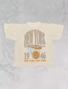 Show the love for your favorite team in this New York Basketball oversized tshirt that is inspired by vintage 90s N B A tshirts!- Features New York Basketball across the top with a basketball hoop and 1946 with New York, New York underneath all in a Blue and orange ink- Screen print transfer that is heat pressed onto each tshirt- Tshirt is a super soft vintage wash that gets softer after each wash- Oversized fit- Sizing translation: XS/S = L , S/M = XL , L/XL = 2XL , 2XL/3XL = 3XL- 100% Cotton**due to screens & filters color may vary from pictures** Basketball Tshirt Designs, New York Basketball, Basketball Tshirt, 90s Sports, Merch Ideas, Screen Print Transfer, Print Transfer, Western Chic, Design Posters