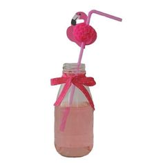 a pink flamingo drink in a mason jar with a straw and ribbon on top