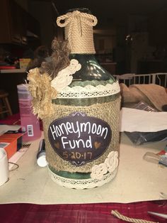 a bottle that has been decorated with burlap and twine on the top