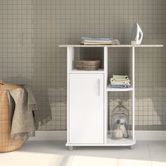 a small white cabinet sitting in front of a tiled wall