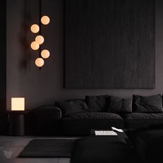 a living room filled with black furniture and lights