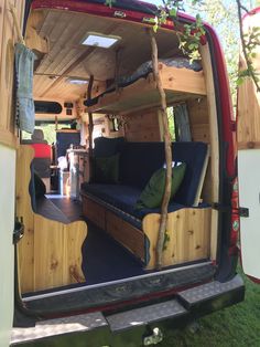 the back end of a van with couches in it