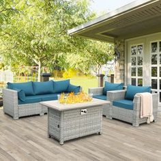 an outdoor patio with blue cushions and furniture