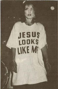 an older woman wearing a jesus looks like me t - shirt in black and white