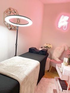 a room with pink walls and black bed in the corner, white fur rugs on the floor