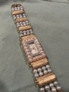 "This beautiful vintage wrist watch features four columns of pearls threaded through 14K gold scroll beads.  The watch face is small and rectangular, surrounded by 18 small diamonds.  This piece is signed in the traditional Lucien Piccard arc and bears a serial stamp \"C2244.\"   Unknown if the watch works but can easily be tended to by an experienced watchmaker.  Please ask questions! I am happy to answer as best as I can.  If you are familiar with this brand, you know this price is an absolute bargain.  **Accepting offers This stunning piece is from an estate collection of a family friend.  She was a lovely fashion model, a world traveler, and with her most popular years in the 80s and 90s.  She found home in her later years in beautiful Colorado.  She had an eclectic style and it's time Elegant Rectangular Jewelry And Watches For Evening, Vintage Rectangular Jewelry With Diamond Hour Markers, Vintage Rectangular Diamond Watch With Diamond Hour Markers, Antique Gold Diamond Watch For Evening, Antique Gold Diamond Evening Watch, Elegant Rectangular Jewelry With Diamond Hour Markers, Heirloom Gold Jewelry And Watches For Wedding, Elegant Rectangular Gold Jewelry And Watches, Elegant Rectangular Yellow Gold Diamond Watch