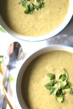 two bowls filled with soup and garnished with cilantro