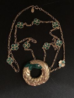 Lanvin's designer necklace consisting of clovers measuring 1.4 cm enamelled in green color and a gold metal medallion and crystals measuring 5 cmSmall imperfections is a vintage product Vintage Yellow Gold Enamel Necklace, Formal Enamel Medallion Necklace, Elegant Enamel Medallion Necklace, Green Medallion Necklace For Formal Occasions, Vintage Green Necklace With Chain, Victorian Gold Enamel Necklace, Elegant Enamel Necklace With Chain, Vintage Green Long Necklace, Formal Green Locket Necklace