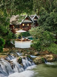 there is a small waterfall in front of the house